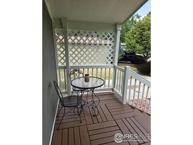 a view of balcony with wooden floor and outdoor seating