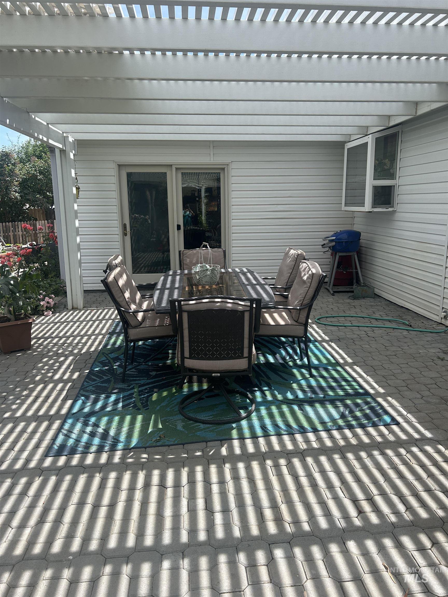 1444 East Doberman Street Meridian, ID 83642 - Photo 25 of 31 Expansive paver patio with a white pergola providing partial shading