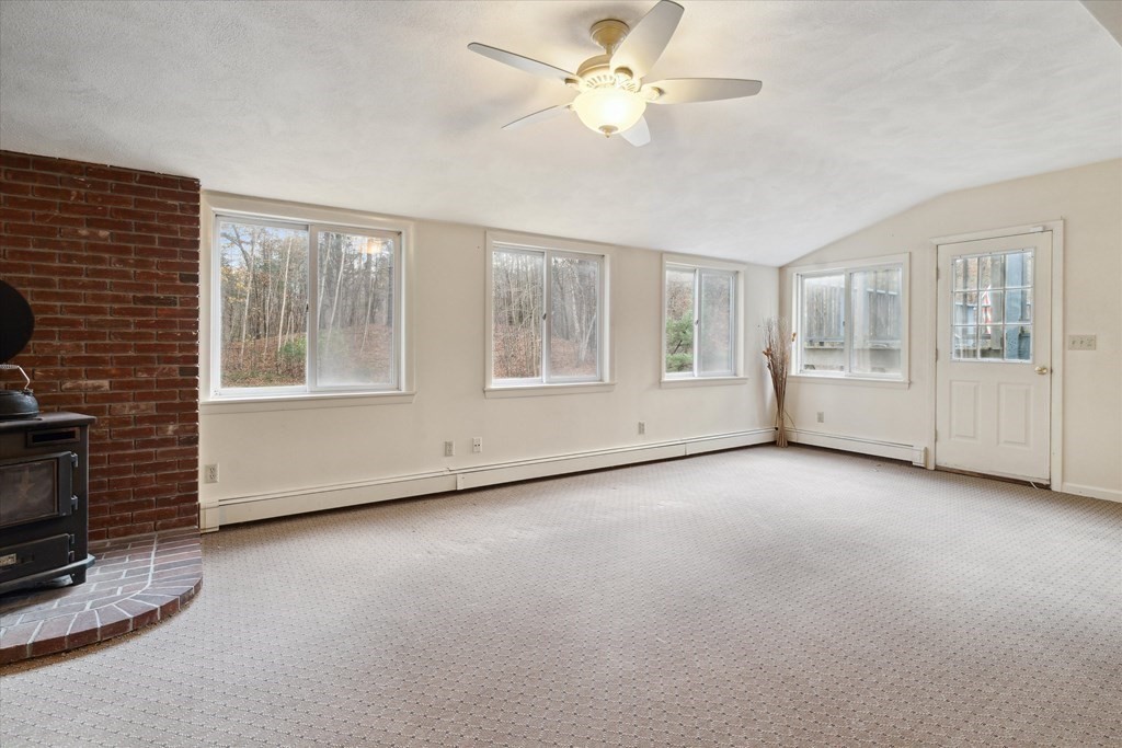 13 Highland Road Boxford, MA 01921 - Photo 15 of 35 a view of an empty room with a fireplace and a window