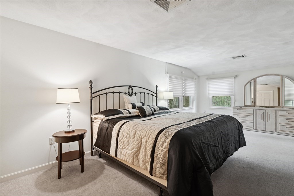 13 Highland Road Boxford, MA 01921 - Photo 9 of 35 a bedroom with a bed wooden floor and window