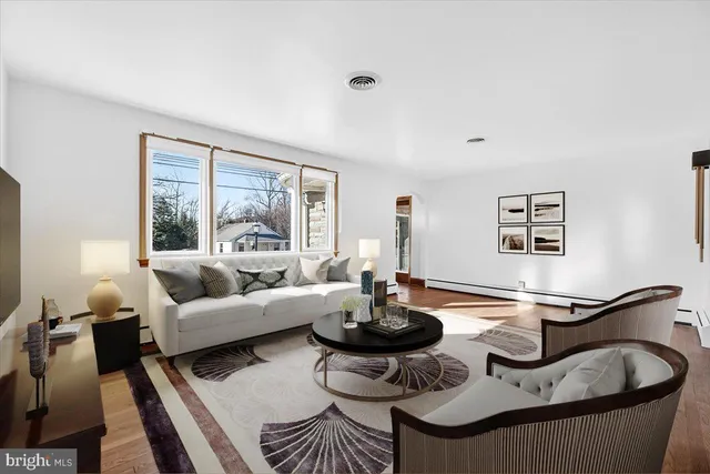 a living room with furniture and floor to ceiling windows