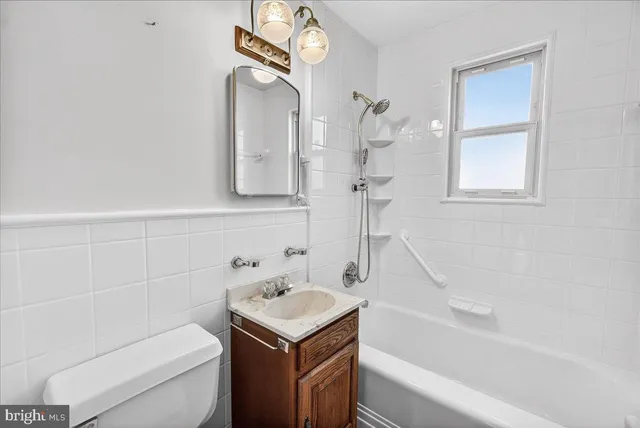 a bathroom with a sink a toilet and bathtub