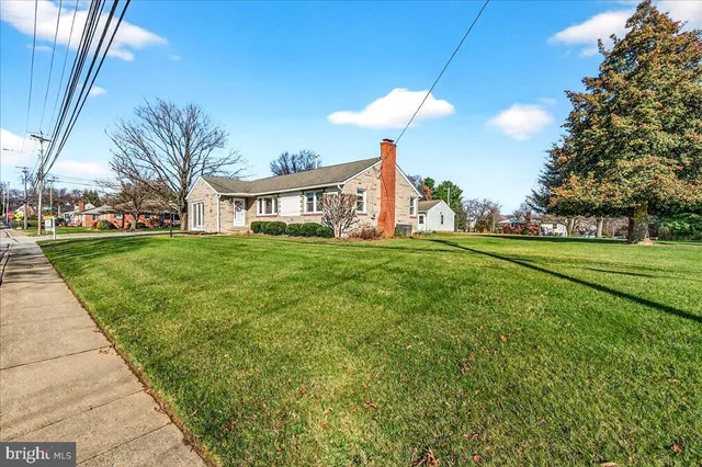 a front view of a house with a yard table and chairs