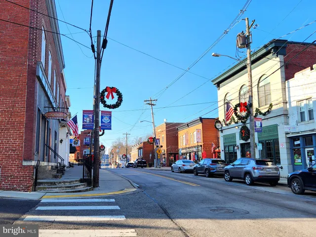 a front view of a house with a yard and lake view