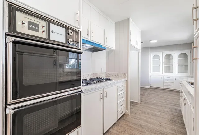 a kitchen with stainless steel appliances granite countertop a stove and a refrigerator