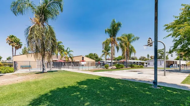 a view of a yard and swimming pool