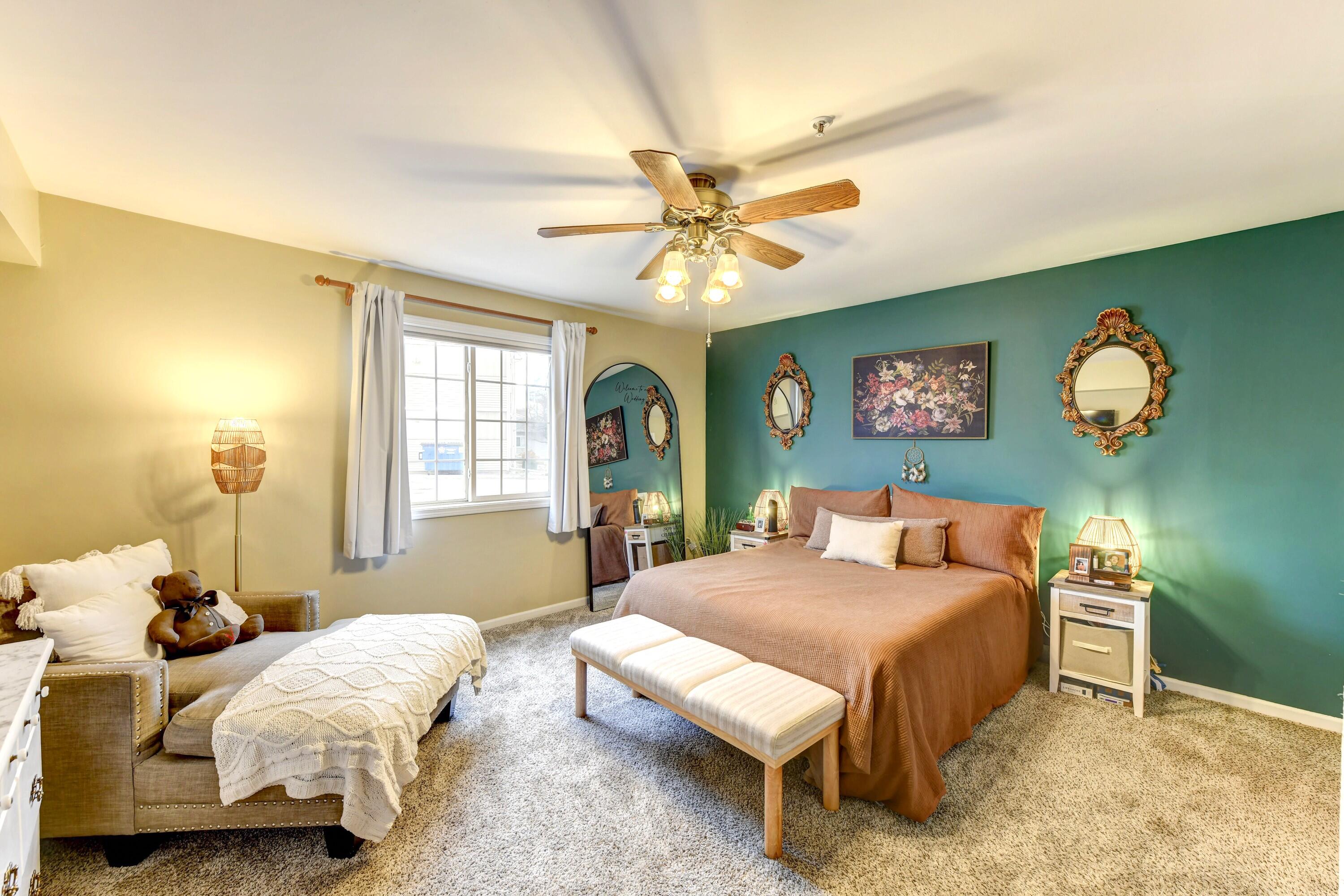 2343 99th Street, Unit 1A Highland, IN 46322 - Photo 11 of 18 a bedroom with a bed and a chandelier