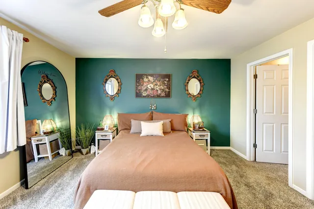 a bedroom with a bed and a chandelier