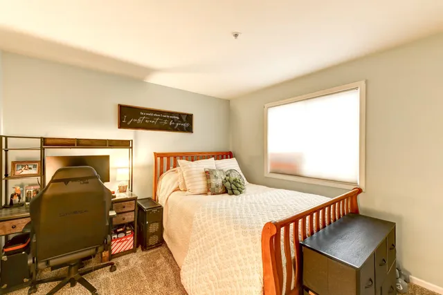 a bedroom with furniture and a window