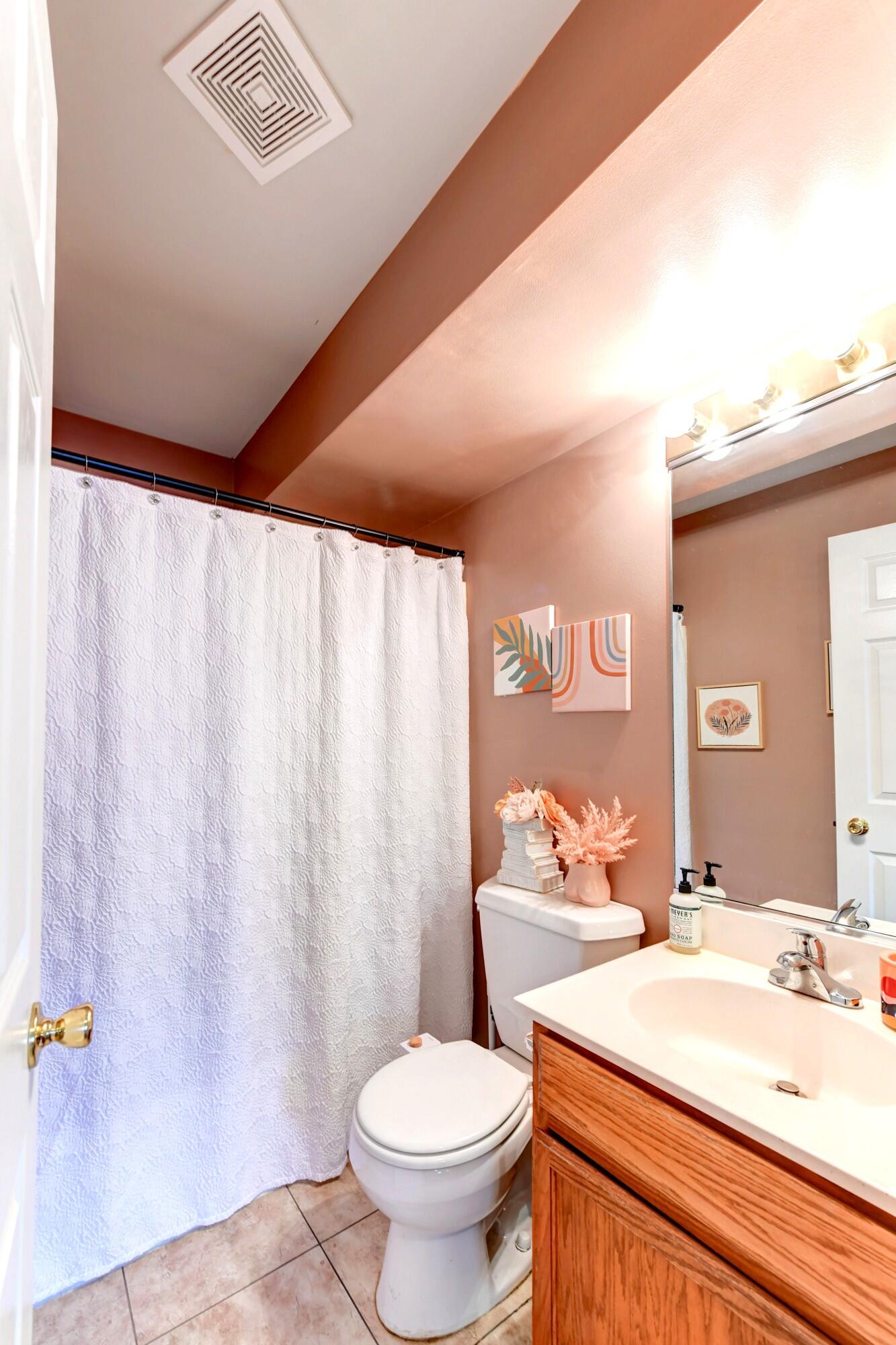 2343 99th Street, Unit 1A Highland, IN 46322 - Photo 15 of 18 a bathroom with a toilet sink and mirror