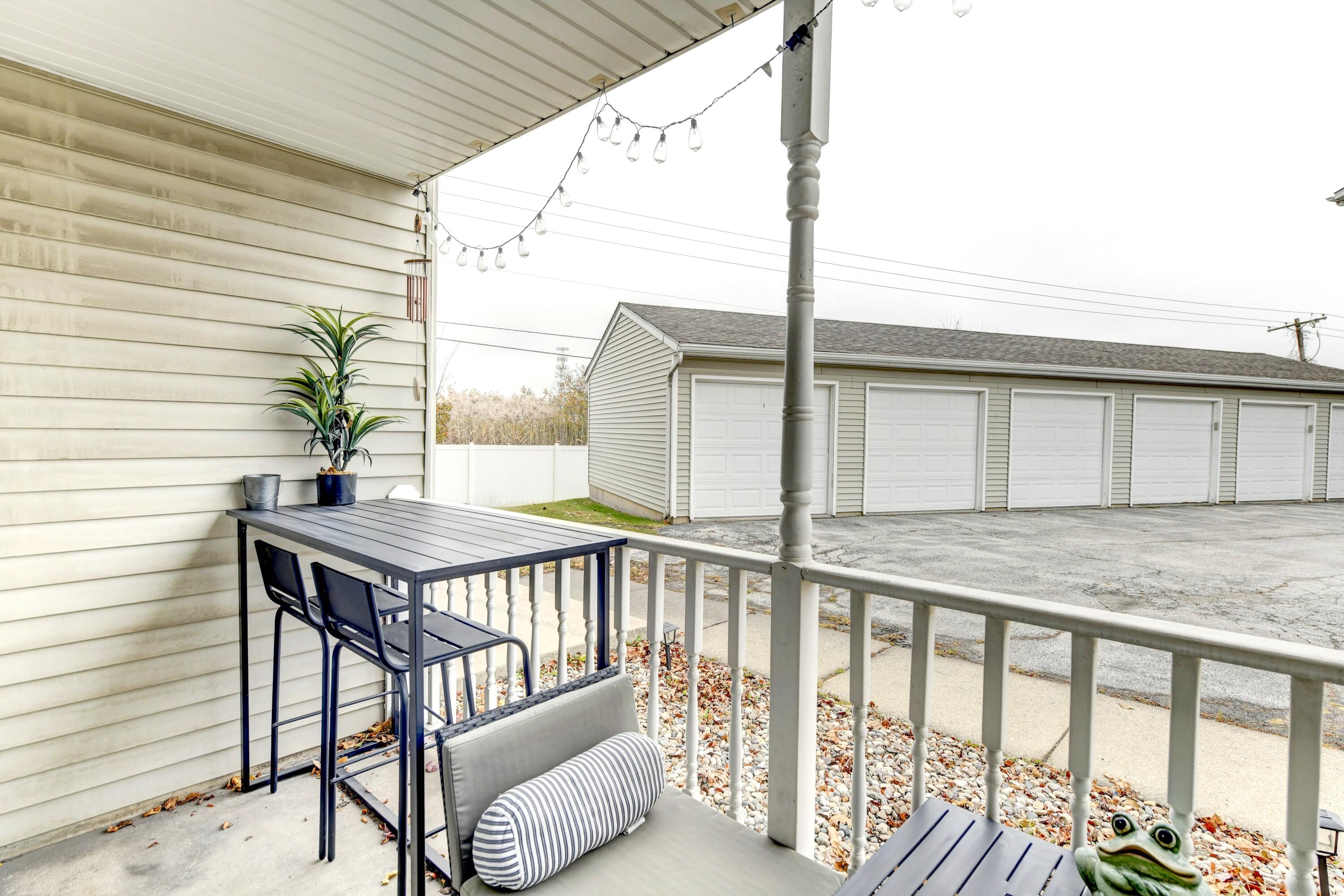 2343 99th Street, Unit 1A Highland, IN 46322 - Photo 17 of 18 a roof deck with wooden floor and fence