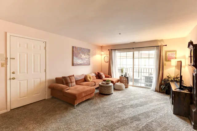 a living room with furniture and large windows