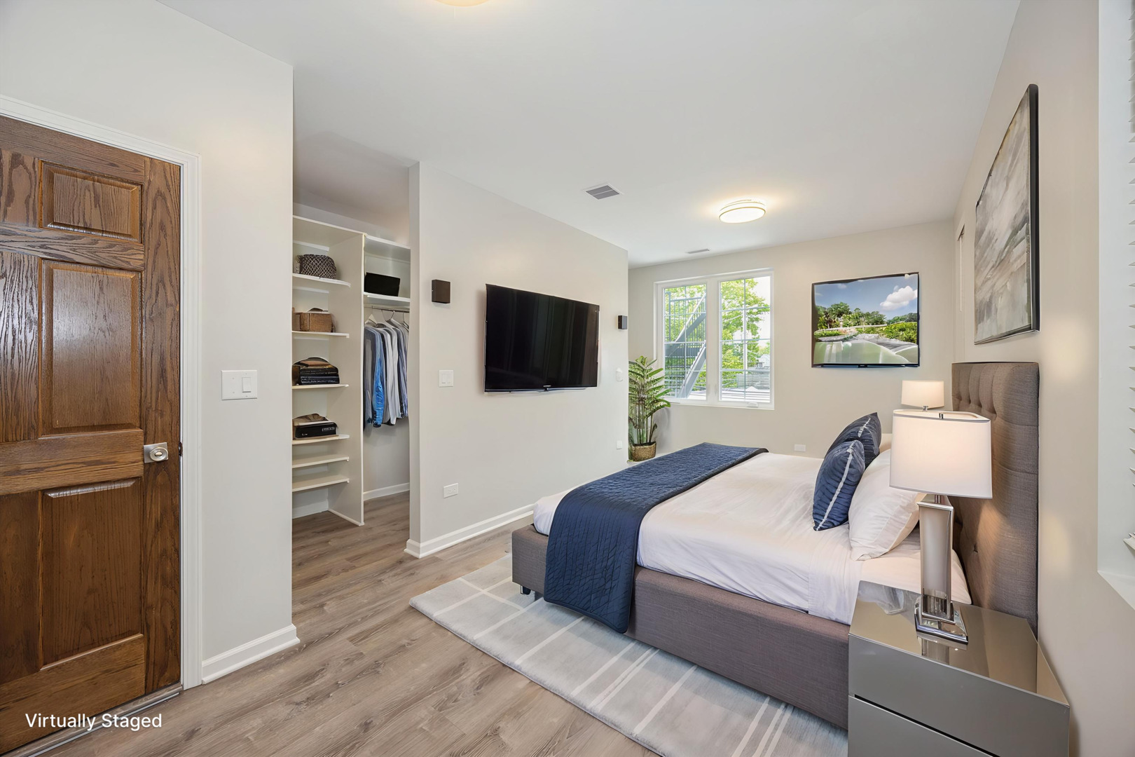 2008 West Addison Street, Unit 2 Chicago, IL 60618 - Photo 12 of 19 a bedroom with a bed and a flat screen tv