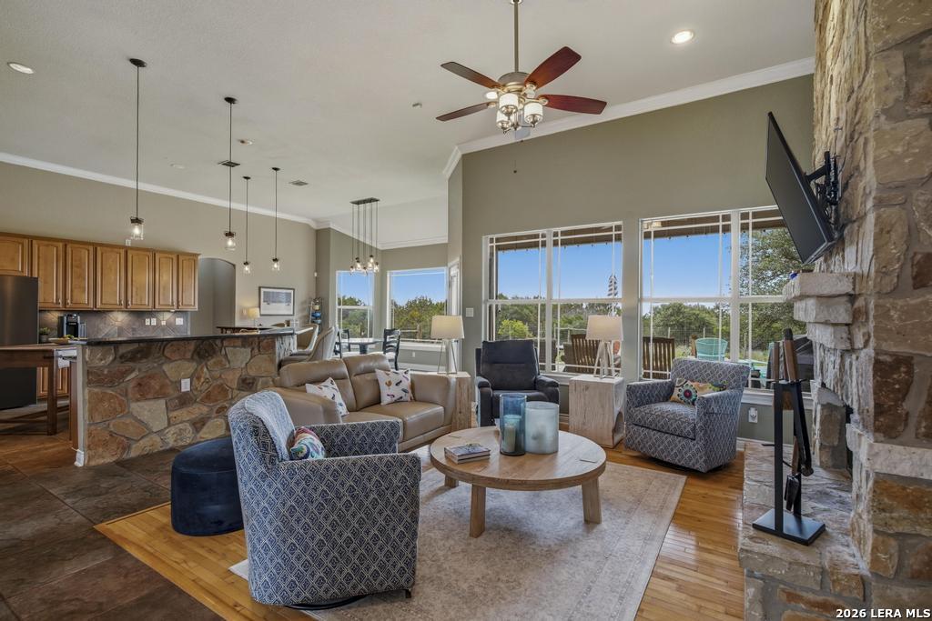 101 Shady Ridge Drive Boerne, TX 78006 - Photo 8 of 44 a living room with fireplace furniture and a large window