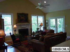 11207 Asbury Chapel Road Huntersville, NC 28078 - Photo 3 of 8 a living room with furniture a large window and a fireplace