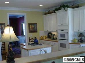 11207 Asbury Chapel Road Huntersville, NC 28078 - Photo 4 of 8 a kitchen with stainless steel appliances granite countertop a stove and a refrigerator