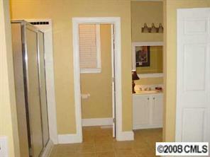 11207 Asbury Chapel Road Huntersville, NC 28078 - Photo 5 of 8 a view of a bathroom with a door and wooden door