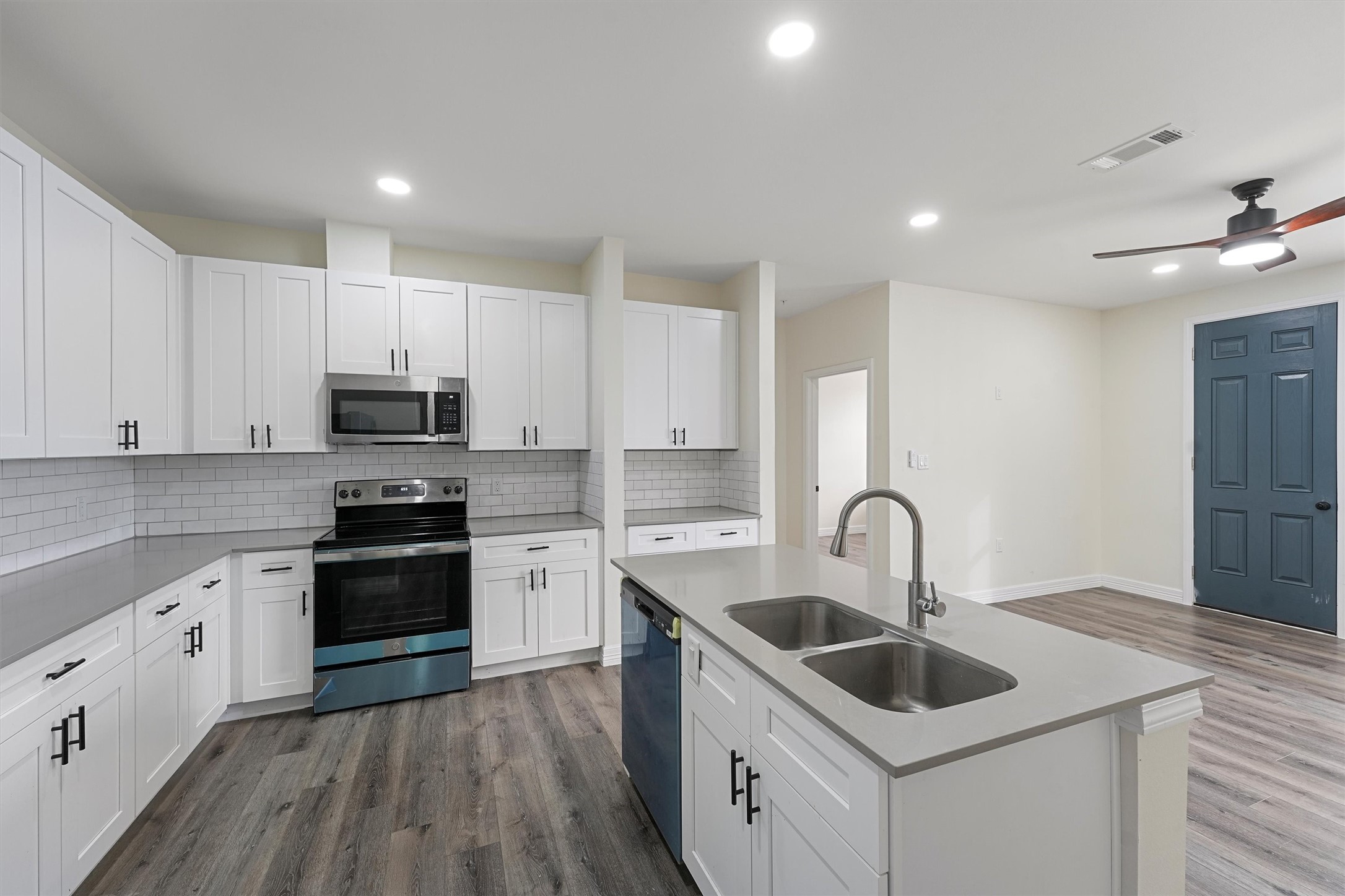 a kitchen with stainless steel appliances granite countertop a sink stove and refrigerator