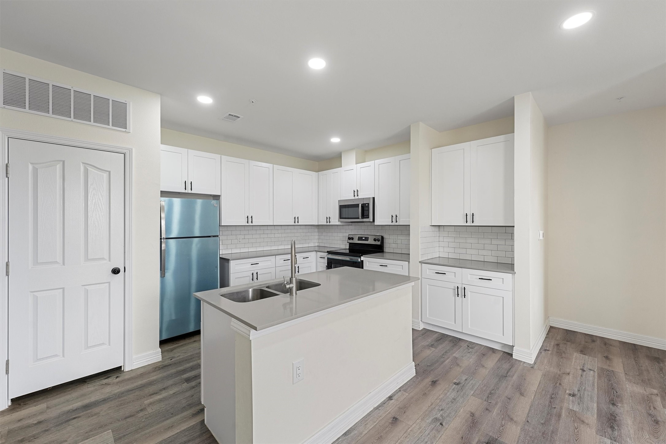 2130 Aldine Mail Rte Road, Unit B103 Houston, TX 77039 - Photo 2 of 9 a kitchen with stainless steel appliances a refrigerator sink and cabinets