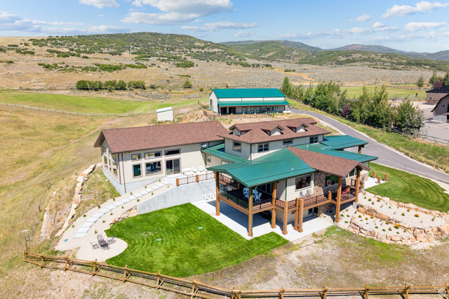 6117 North Rocky Ridge Road Peoa, UT 84061 - Photo 13 of 82 Multi-level residence featuring a green metal roof and a stone facade