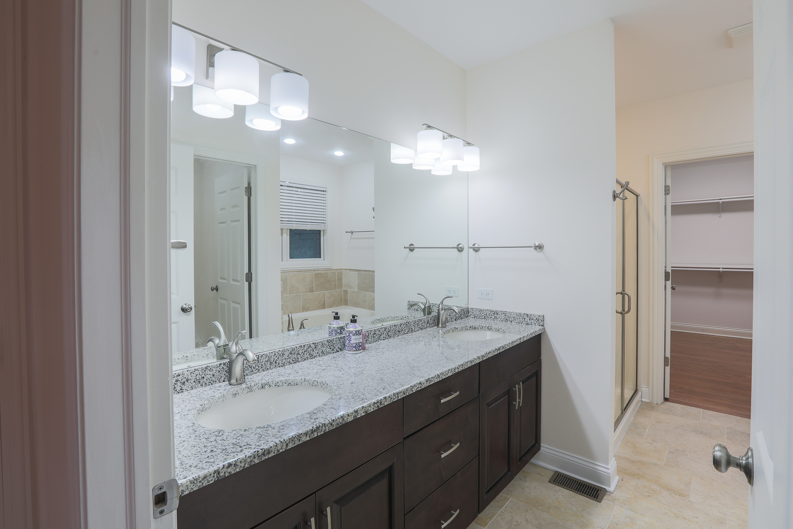7820 South County Line Road Burr Ridge, IL 60527 - Photo 23 of 40 a bathroom with a granite countertop double vanity sink and a mirror