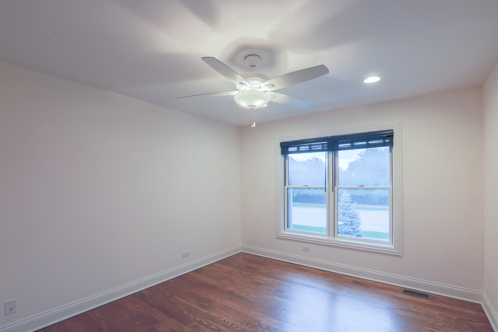 7820 South County Line Road Burr Ridge, IL 60527 - Photo 27 of 40 an empty room with wooden floor and windows