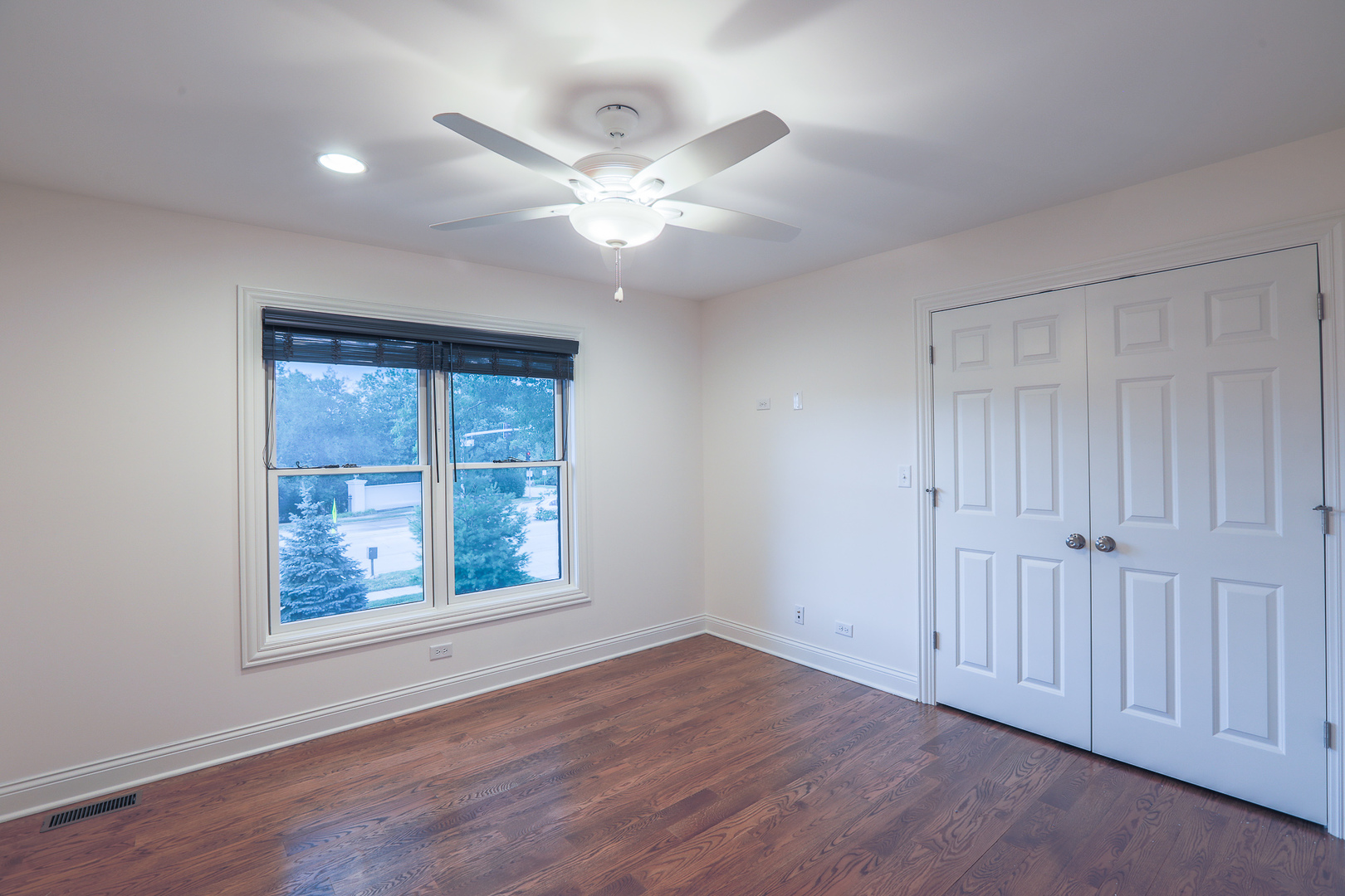 7820 South County Line Road Burr Ridge, IL 60527 - Photo 30 of 40 an empty room with wooden floor fan and windows