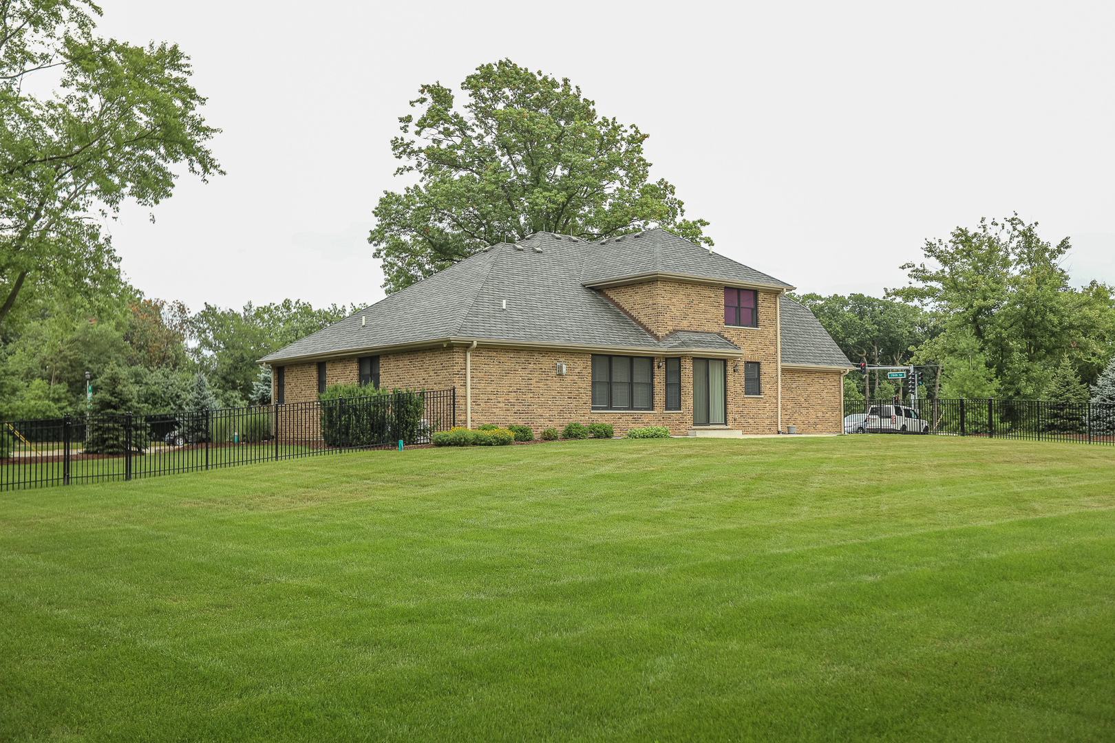 7820 South County Line Road Burr Ridge, IL 60527 - Photo 4 of 40 a front view of a house with a yard