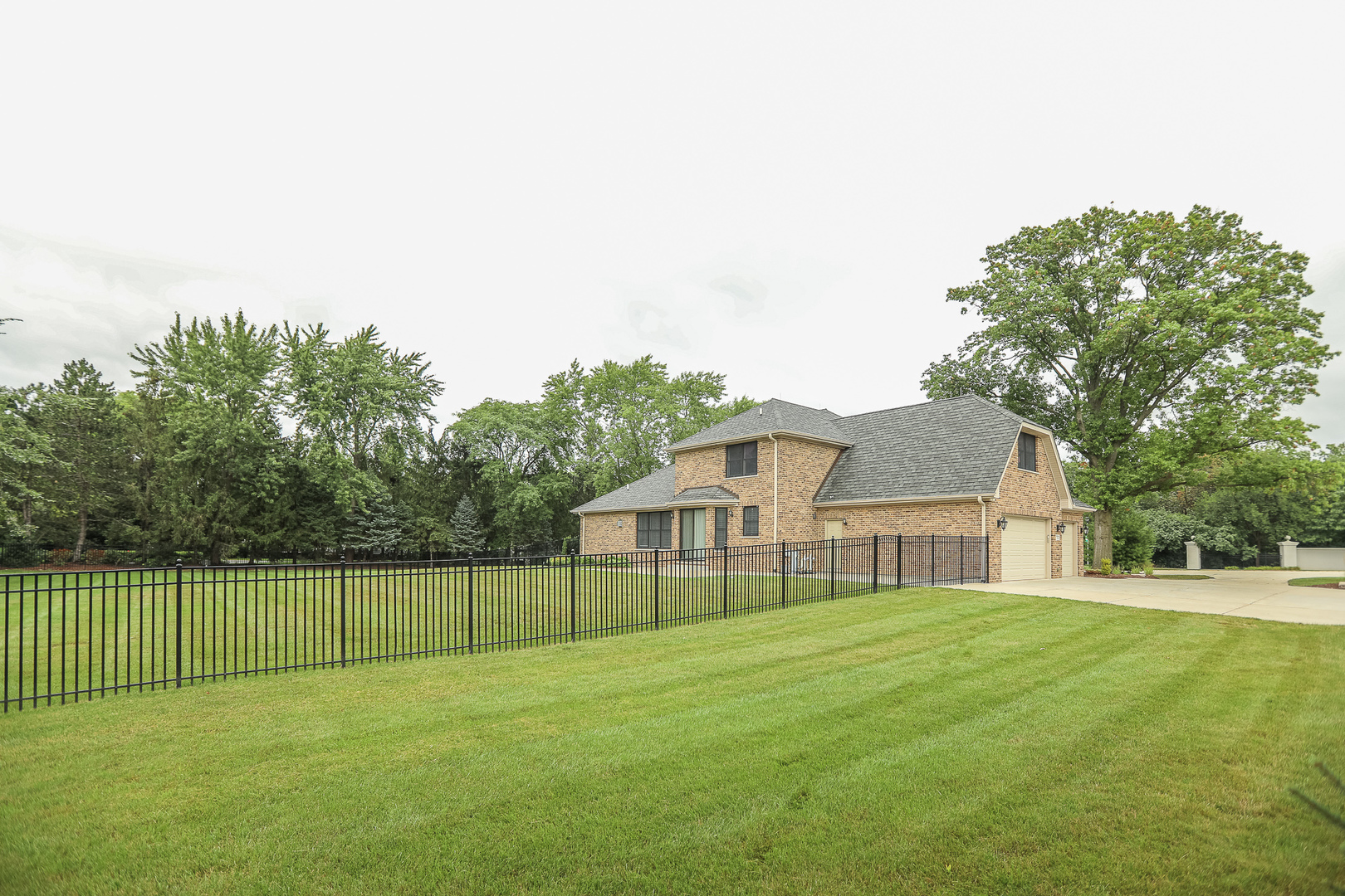 7820 South County Line Road Burr Ridge, IL 60527 - Photo 6 of 40 a view of a house with a big yard and large trees