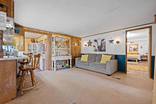 a living room with furniture and a floor to ceiling window