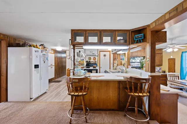 a living room with furniture a flat screen tv and a window