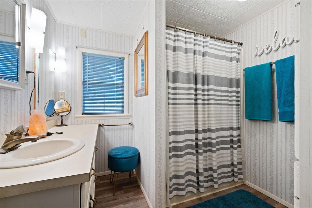 1500 County Road 404 Comanche, TX 76442 - Photo 28 of 39 a bathroom with a sink a toilet and shower
