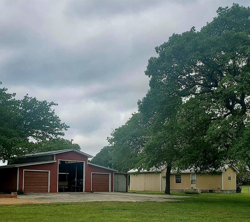 1500 County Road 404 Comanche, TX 76442 - Photo 30 of 39 a front view of a house with a yard and trees