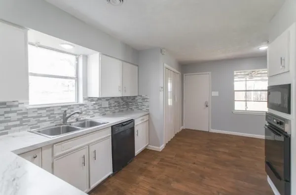 a kitchen with a sink stove and cabinets