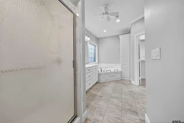 a bathroom with a glass shower door and a toilet