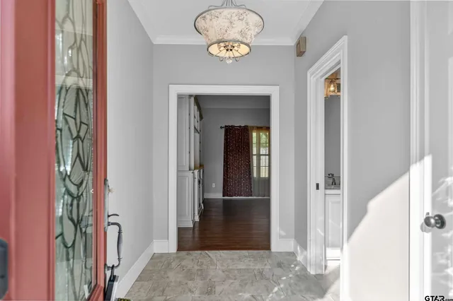 a view of a hallway with wooden floor and entryway
