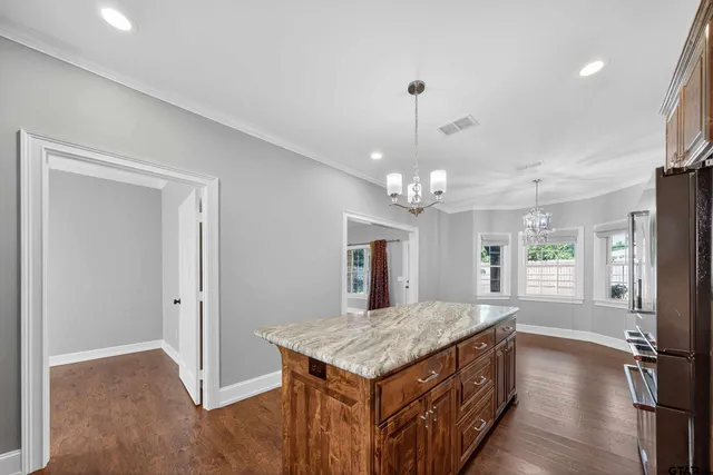a kitchen that has a lot of counter space and a wooden floor
