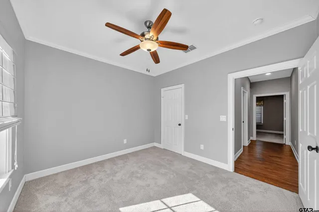 a view of a livingroom with a ceiling fan and window