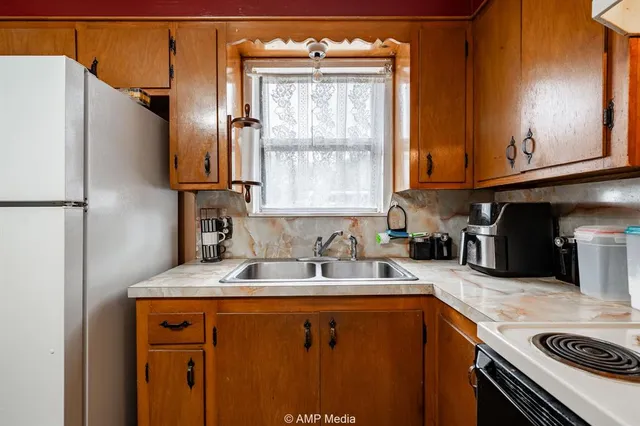 a kitchen with stainless steel appliances granite countertop a refrigerator and a stove