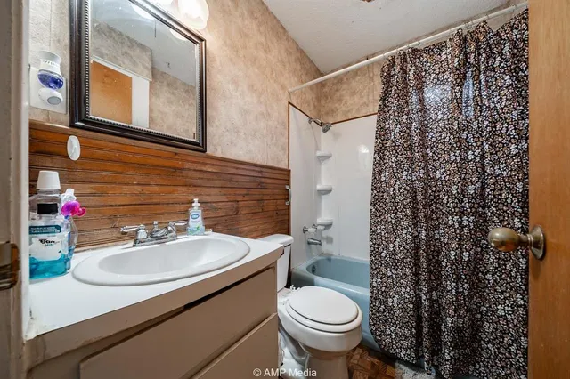 a bedroom with furniture and a flat screen tv