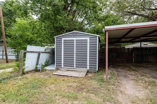a view of a house with backyard and sitting area