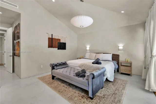 a bedroom with bed and a chandelier