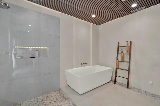 a bathroom with a bathtub and shower