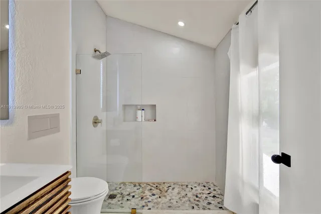 a bathroom with a shower toilet and sink