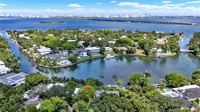 an aerial view of a house with a garden and lake view