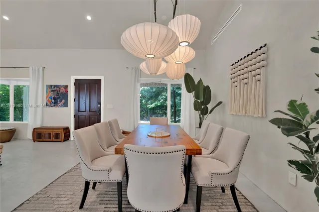 a dining room with furniture a livingroom and chandelier
