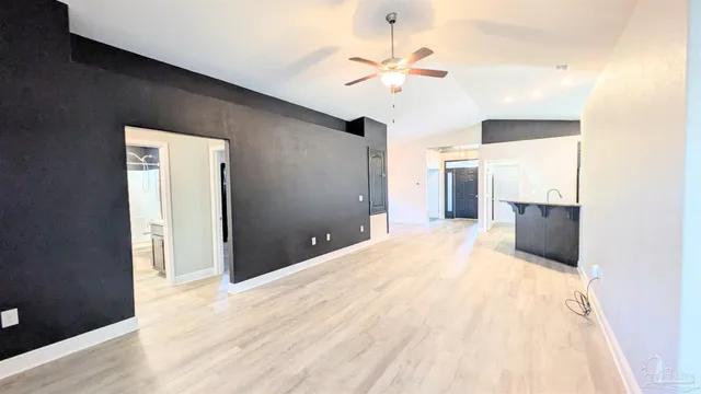 a view of a kitchen with a sink and a refrigerator