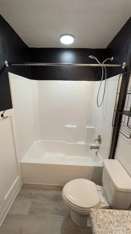 a bathroom with a toilet and a shower