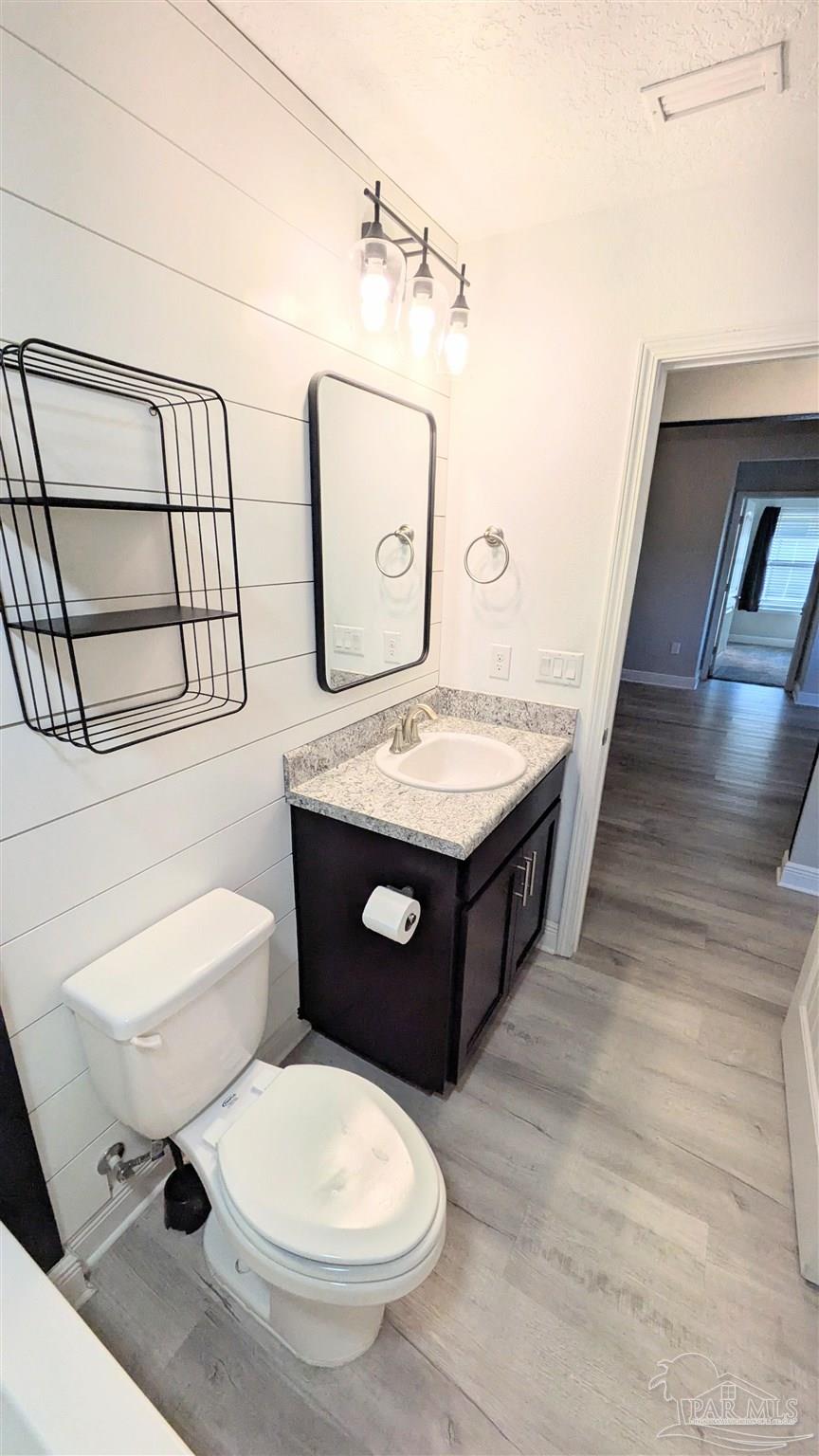 4417 Fiske Street Pace, FL 32571 - Photo 31 of 38 a bathroom with a toilet a sink and mirror