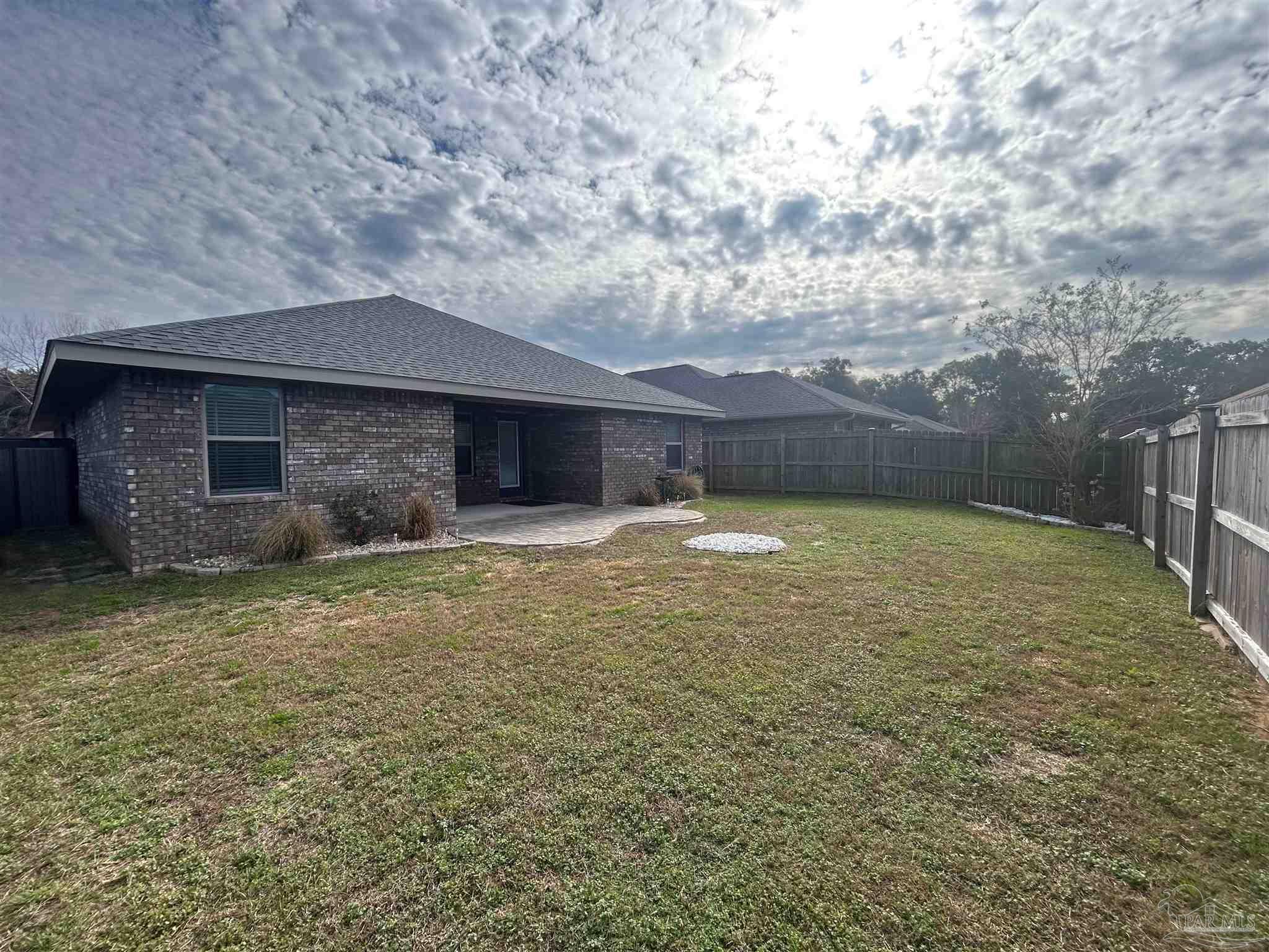 4417 Fiske Street Pace, FL 32571 - Photo 38 of 38 a swimming pool with outdoor seating and yard